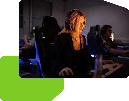 Women at computer holding a computer mouse and sitting in a gaming chair.