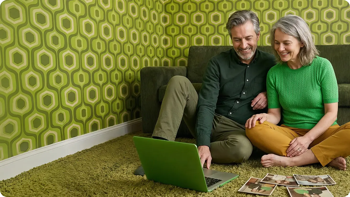 Smiling older couple viewing laptop PC together.