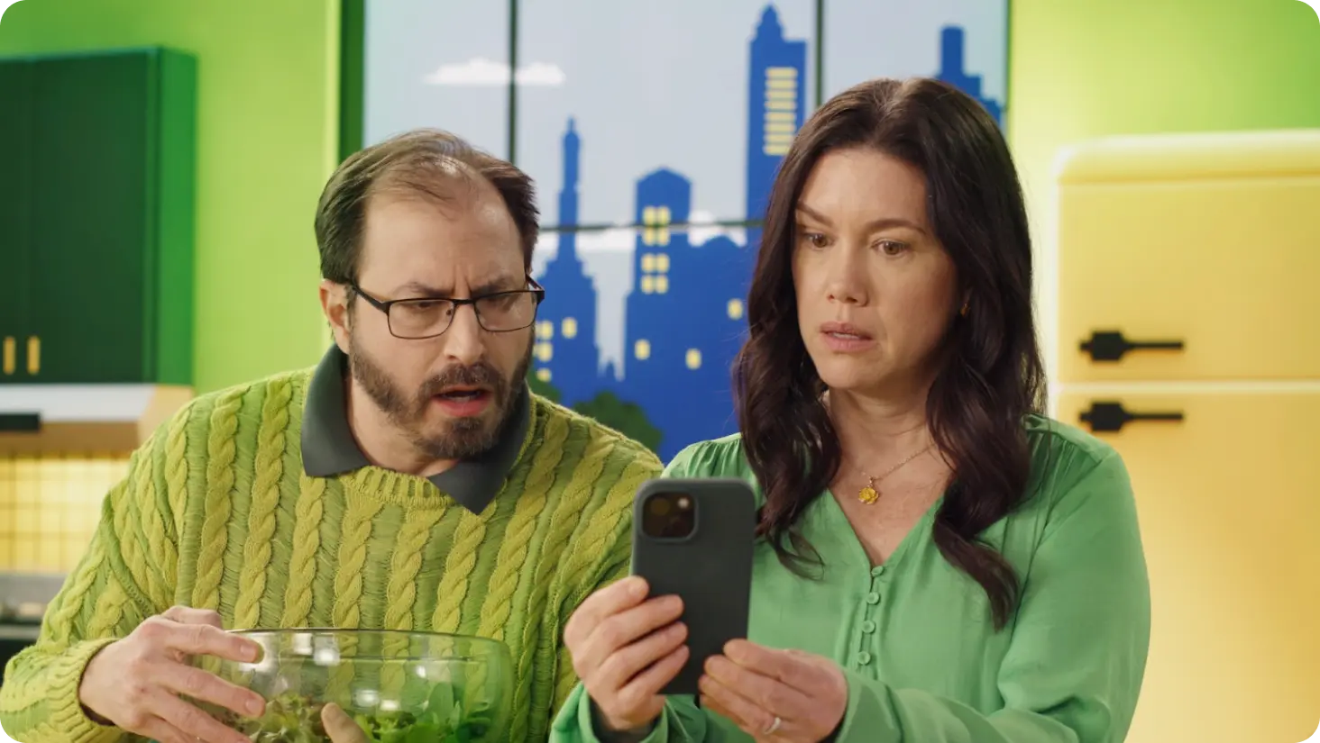 Alarmed couple viewing smart phone.