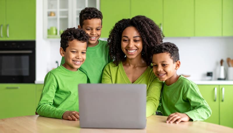 A family looking at a laptop.