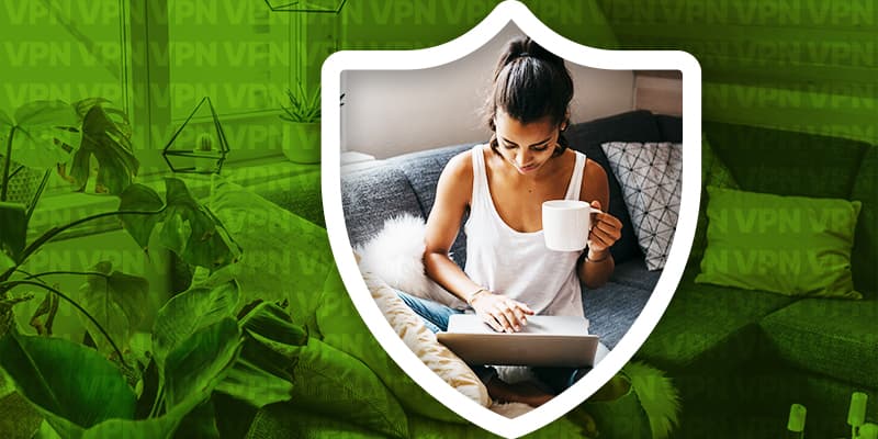 Person using a laptop at home with a coffee cup, symbolizing VPN protection and secure online browsing.